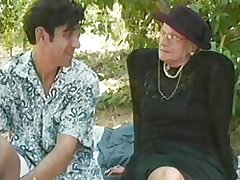 GRANNY AWARD 5 kermis  mature with a young man outdoor